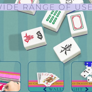 May include: White Mahjong tiles with red and green markings are scattered on a teal surface. The image includes the text "WIDE RANGE OF USES". The tiles are shown with other games like dominoes and playing cards.
