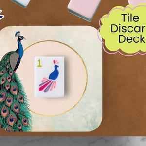 May include: A decorative tile discard deck featuring a peacock illustration. The deck includes a tile with a peacock design and the number 1. The words "Tile Discard Deck" are in a yellow cloud-shaped text box. The background is a mix of brown and light green.