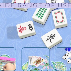 May include: White Mahjong tiles with red and black symbols are scattered on a light blue floral patterned surface. The text "WIDE RANGE OF USES" is at the top. The image also shows playing cards, dominoes, and more Mahjong tiles.