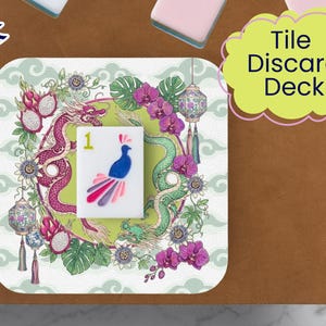 May include: A square tile discard deck with a colorful design. The tile features a peacock illustration with a number 1. The background includes a dragon, flowers, and lanterns. The text "Tile Discard Deck" is in a yellow cloud.