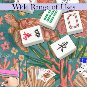 May include: A selection of white Mahjong tiles, featuring red, green, and black symbols, are arranged on a teal and coral patterned surface. The image also shows a turtle and fish illustration, playing cards, and dominoes. The text "Wide Range of Uses" is visible.
