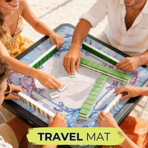 May include: A square mahjong travel mat with a blue crab design. The mat is surrounded by players holding mahjong tiles. The text "TRAVEL MAT" is displayed in a yellow banner at the bottom of the image.
