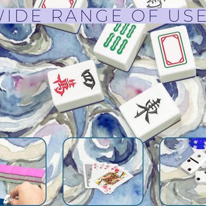 May include: White Mahjong tiles with red, green, and black symbols are scattered on a blue and white watercolor background. The image includes the text "WIDE RANGE OF USES" at the top. Additional images show playing cards, dominoes, and more Mahjong tiles.