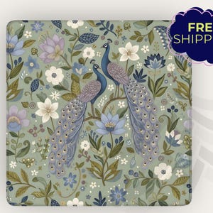 May include: Square decorative item with a floral and peacock design. The background is a muted green with white, blue, and purple flowers. Two blue peacocks are perched on a branch. The text "FREE SHIPPING" is in a dark blue cloud.