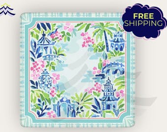 May include: Square coaster with a colorful floral and pagoda design. The coaster features a light blue border and a central design with pink flowers, green leaves, and blue pagodas. The words "FREE SHIPPING" are in a dark blue bubble.