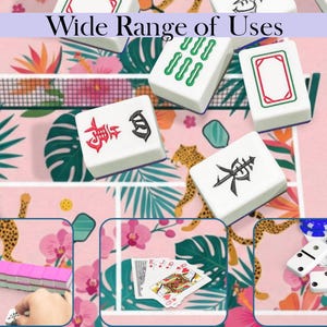 May include: A collection of white Mahjong tiles with red and black symbols, arranged on a pink floral patterned surface. The image also shows dominoes and playing cards, with the text "Wide Range of Uses" at the top.