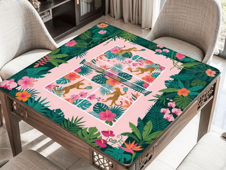 May include: A square wooden table with a pink and green floral design. The table's surface features a tennis court design with cheetahs playing. The edges are adorned with tropical flowers and foliage.