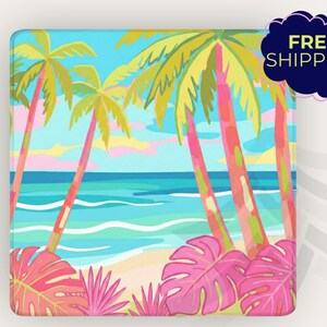 May include: Square decorative item with a tropical beach scene. The artwork features palm trees with pink trunks, turquoise water, and a sandy beach. The sky is a mix of blue, pink, and yellow. The text "FREE SHIPPING" is in a dark blue cloud.