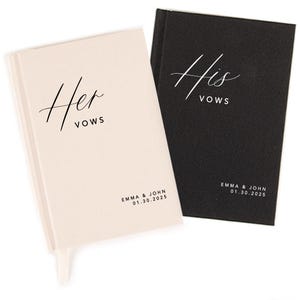 May include: Two small, hardcover vow books. One is cream-colored with "Her Vows" in elegant script, the other is black with "His Vows". Both books have the names "Emma & John" and the date "01.30.2025" printed at the bottom.
