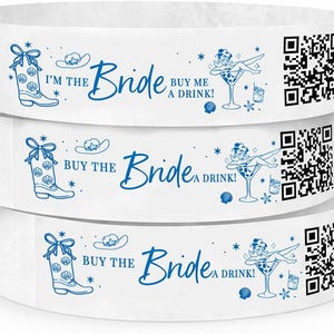 May include: White wristbands with blue text and illustrations. The text reads "I'M THE Bride BUY ME A DRINK!" and "BUY THE Bride A DRINK!". Designs include a cowboy boot, a cowboy hat, a woman in a martini glass, and QR codes.