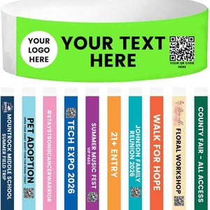 May include: A white and green wristband with the text "YOUR TEXT HERE" and a QR code. Below are colorful wristbands with text including "PET ADOPTION", "TECH EXPO 2026", and "COUNTY FAIR - ALL ACCESS".