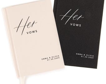 May include: Two vow books, one cream and one black, with the word "Her" in elegant script and "VOWS" below. The names "EMMA & OLIVIA" and the date "01.30.2025" are printed at the bottom.