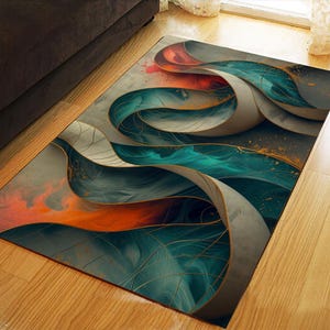 May include: Abstract area rug with a flowing design in teal, gray, and orange. The rug features curved, layered shapes with gold accents, creating a modern and artistic look. The rug is rectangular and placed on a wooden floor.