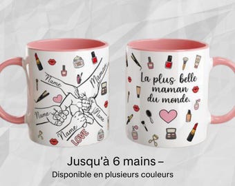 May include: Two white ceramic mugs with pink interiors and handles. One mug features hands holding each other, with the words "Name", "Love", and "Maman". The other mug has the text "La plus belle maman du monde" and makeup illustrations.