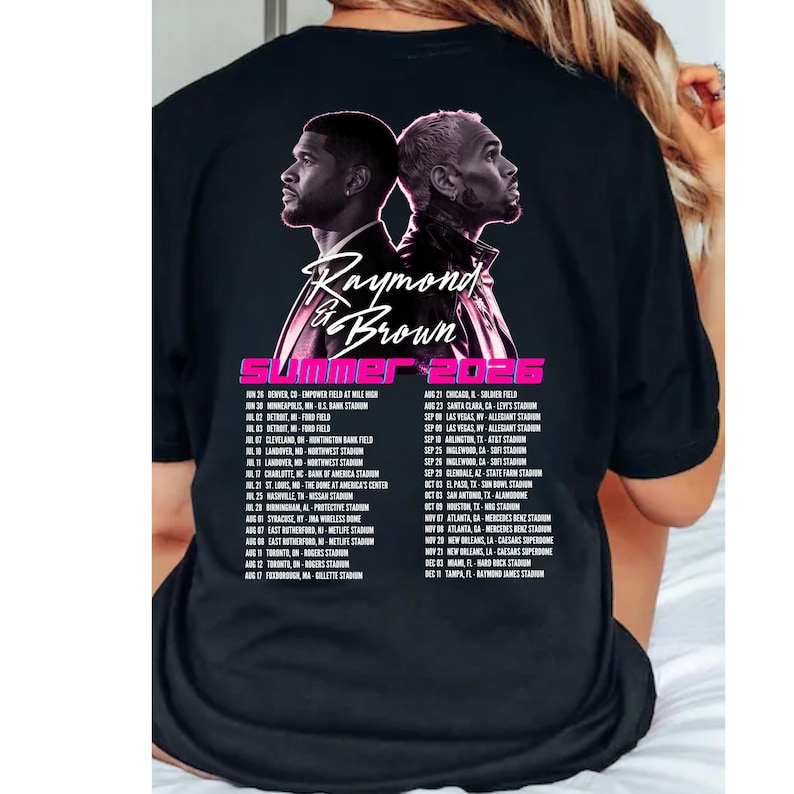 May include: A black t-shirt featuring a graphic of two men back-to-back with the text Raymond & Brown, Summer 2026, and a list of tour dates and locations printed in white and pink on the back of the garment, showcasing a concert tour design.