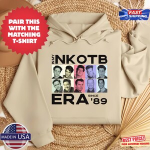 May include: A beige hoodie featuring a grid of nine black and white headshots with the text "IN MY NKOTB ERA SINCE '89". The hoodie has a drawstring hood and long sleeves. The image also includes a red starburst that says "PAIR THIS WITH THE MATCHING T-SHIRT".