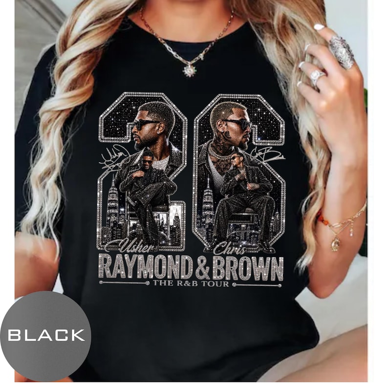 May include: A black t-shirt featuring a graphic print of two men in sunglasses, set within large glittery number frames. The text reads Usher, Chris, Raymond & Brown, and The R&B Tour. The design includes city skylines and star-like sparkles.