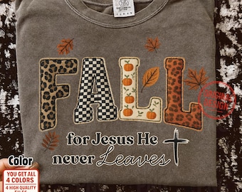 May include: A gray sweatshirt with the word "FALL" in a mix of leopard print, checkered, and pumpkin-themed letters. The text "for Jesus He never Leaves" and a cross are below the word "FALL".