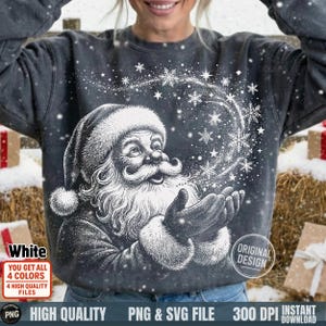 May include: Dark gray sweatshirt featuring a detailed white illustration of Santa Claus with a long beard and hat, surrounded by snowflakes. The text "White" and "Original Design" are visible. The image also includes text indicating high-quality PNG and SVG files.