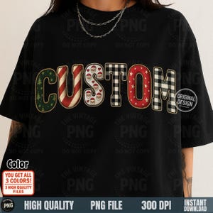 May include: Black t-shirt with the word "CUSTOM" in a festive design. The letters feature patterns like Christmas trees, candy cane stripes, Santa faces, buffalo check, and stars. The shirt includes the text "ORIGINAL DESIGN".