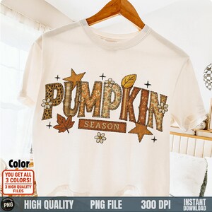 Hanging white shirt with patchy fall letters spelling “Pumpkin Season”