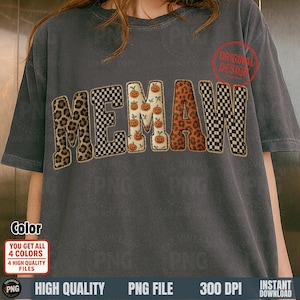 May include: A gray t-shirt with the word "MEMAW" in a decorative font. The letters have different patterns: leopard print, checkered, and pumpkin print. The shirt has a vintage look, with additional text and graphics.