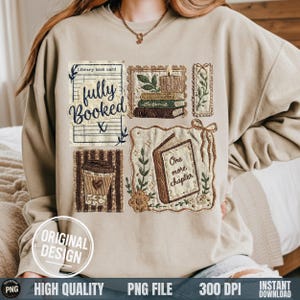 May include: Beige sweatshirt with embroidered patches featuring book-themed designs. Patches include a library book card with "fully booked", stacks of books, a coffee cup, and an open book with "One more chapter". "Original Design" text is visible.