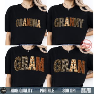 May include: A black t-shirt featuring four variations of the word Grandma, Granny, Gram, and Gran in a bold font. Each letter displays a different pattern including leopard print, black and white checkerboard, and a pumpkin print on a cream background.