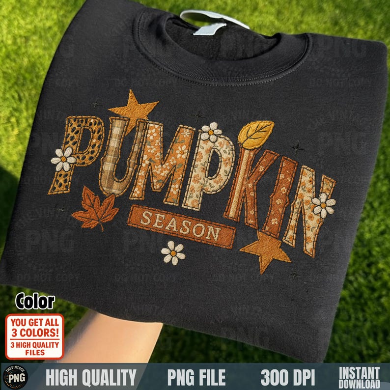Black sweatshirt folded with “Pumpkin Season” patch embroidery artwork