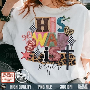 May include: White t-shirt with the phrase "His Way is Better" in colorful, embroidered letters. The design includes hearts, stars, and a cross, with a leopard print accent. The shirt has a vintage design.