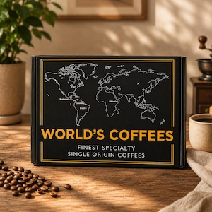 May include: A rectangular black box labeled WORLD'S COFFEES and FINEST SPECIALTY SINGLE ORIGIN COFFEES in yellow and white text. The box features a white outline of a world map with orange dots marking Guatemala, Colombia, Brazil, India, Ethiopia, and Indonesia.