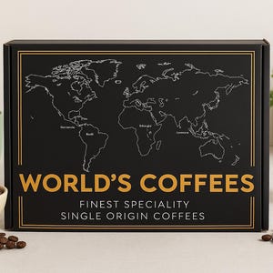 May include: A black box featuring a world map design and the words "WORLD'S COFFEES". The box is accompanied by coffee beans, a green mug, and a glass of coffee. The text on the box also reads "FINEST SPECIALITY SINGLE ORIGIN COFFEES".