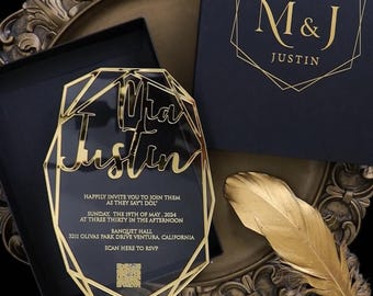 Pode incluir: Um convite de casamento em acrílico preto com bordas geométricas douradas e letras douradas. O texto diz Mia e Justin, Happily invite you to join them as they say I do, Sunday the 19th of May 2024 at three thirty in the afternoon, Banquet Hall, 3211 Olivas Park Drive Ventura, California, Scan here to RSVP.