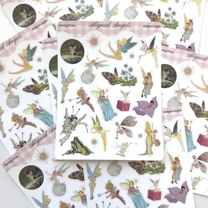 May include: A sticker sheet titled Aligned Angels Dancing Pixies featuring various illustrations of fairies, butterflies, suns, and floral elements. The sheet includes multiple die-cut stickers with diverse poses, wings, and colors on a white background.