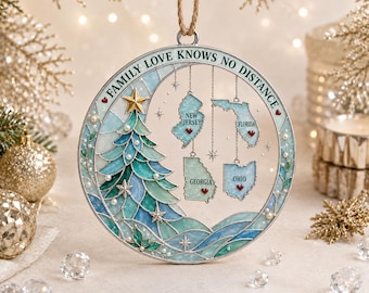 May include: A circular Christmas ornament featuring a stained-glass style tree in shades of blue and green, accented with white pearls and a gold star. Four hanging state outlines for New Jersey, Florida, Georgia, and Ohio are included with the text FAMILY LOVE KNOWS NO DISTANCE and small red hearts.