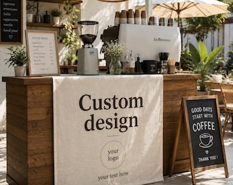 May include: A rustic wooden coffee bar counter draped with a beige linen fabric banner featuring the printed text Custom design, a circular logo placeholder, and your text here. The counter holds a coffee grinder, espresso machine, and menu board.
