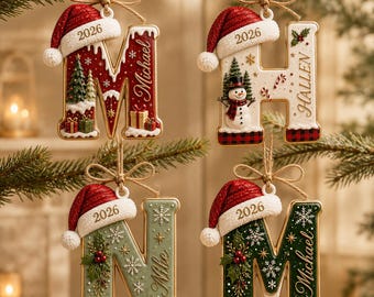 May include: Four hanging Christmas ornaments shaped as letters M, H, N, and M. Each letter features a red Santa hat, the year 2026, and festive details like snow, pine trees, snowmen, holly, and gift boxes. Names Michael, Hallen, and Mike are printed.