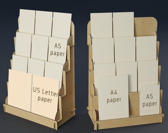 May include: Two wooden display stands with multiple shelves, each holding stacks of paper. One stand displays US Letter and A5 paper, while the other holds A4 and A5 paper. The stands are made of light brown wood.
