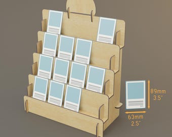May include: A wooden display stand with multiple tiered shelves, designed to hold small cards or prints. The stand is made of light-coloured wood and features a rounded top. Each card measures 8.9 cm high and 6.3 cm wide.