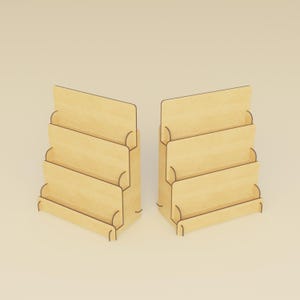 May include: Two wooden display stands with a light wood finish. Each stand has four angled shelves, ideal for showcasing items. The stands are designed with a minimalist aesthetic, suitable for retail or home use.