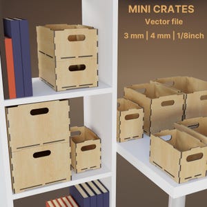 May include: Wooden mini crates in various sizes, stacked and arranged on white shelves. The crates have handle cutouts and are made from light-coloured wood. Text on the image reads "MINI CRATES Vector file 3 mm | 4 mm | 1/8inch".