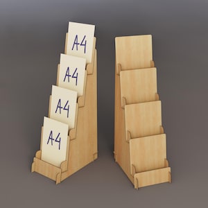 May include: Two wooden display stands with multiple tiers. One stand holds several cream-colored cards labeled "A4" in blue ink. The other stand is empty. The stands are made of light-colored wood and are designed to hold documents or brochures.