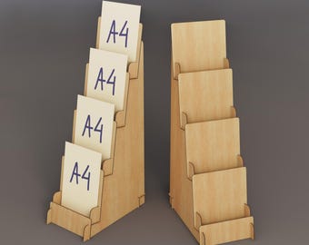 May include: Two wooden display stands with multiple tiers. One stand holds several cream-colored cards labeled "A4" in blue ink. The other stand is empty. The stands are made of light-colored wood and are designed to hold documents or brochures.