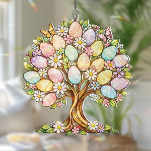 May include: A colorful Easter tree decoration with pastel-colored eggs, daisies, and butterflies. The tree is suspended by a chain and is designed to catch the light. The tree's trunk is brown, and the leaves are green.