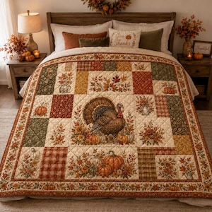 May include: A patchwork quilt featuring a central turkey illustration surrounded by autumn-themed blocks with pumpkins, fall foliage, and plaid patterns in shades of orange, brown, green, and cream, with a quilted texture throughout the fabric.