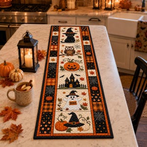 May include: A rectangular quilted table runner featuring a central vertical panel with Halloween motifs including a black cat, owl, pumpkin, haunted house, ghost with the text BOO, and a witch hat, bordered by orange and black patterned fabric.