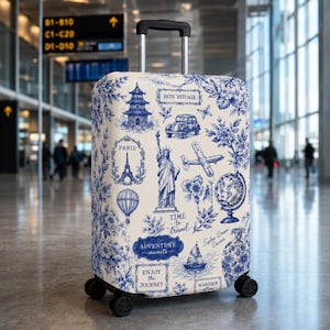 May include: A white suitcase cover featuring a blue toile-style print of travel icons including the Statue of Liberty, Eiffel Tower, a globe, airplane, and sailboat. Text includes "BON VOYAGE," "TIME to travel," "ADVENTURE awaits," and "ENJOY the JOURNEY."