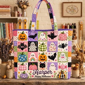 May include: A quilted tote bag featuring a patchwork design of Halloween-themed squares including pumpkins, ghosts, and bats in pastel and vibrant colours. The bottom section displays the text "Harper" and "Happy Halloween" in a dark script font.
