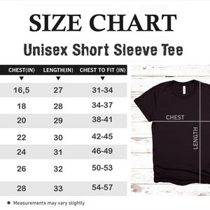 May include: A size chart for a unisex short sleeve tee, with measurements in inches. The chart includes sizes XS to 3XL, with chest and length measurements. A black t-shirt is shown with chest and length indicators.