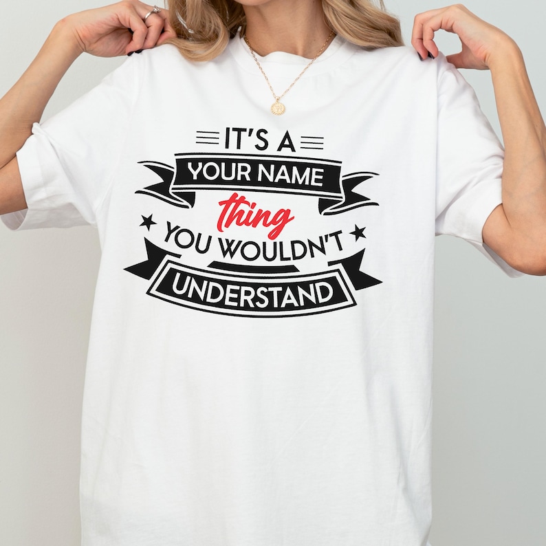 May include: A white short-sleeved t-shirt featuring black and red text that reads IT'S A YOUR NAME thing YOU WOULDN'T UNDERSTAND, arranged with decorative banners and stars. The design is centered on the chest of the garment.
